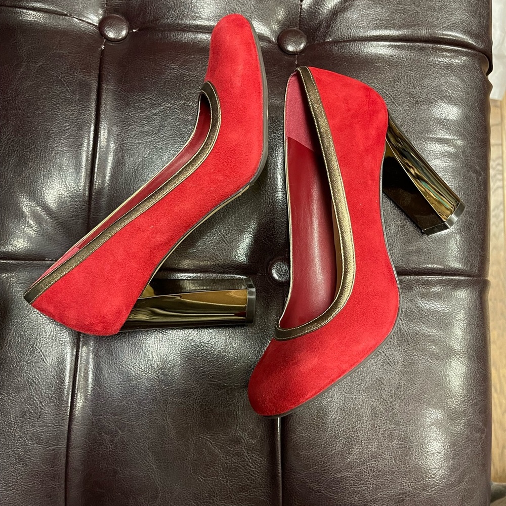 Cole Haan red velvet-textured pumps with gold lining and heels.